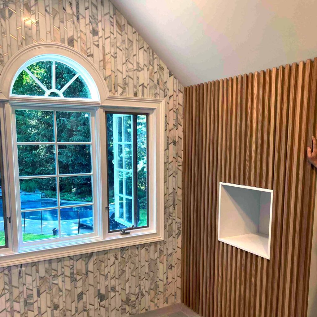 Beautiful mosaic tile and stained wood in a bathroom remodel by White Maple Construction