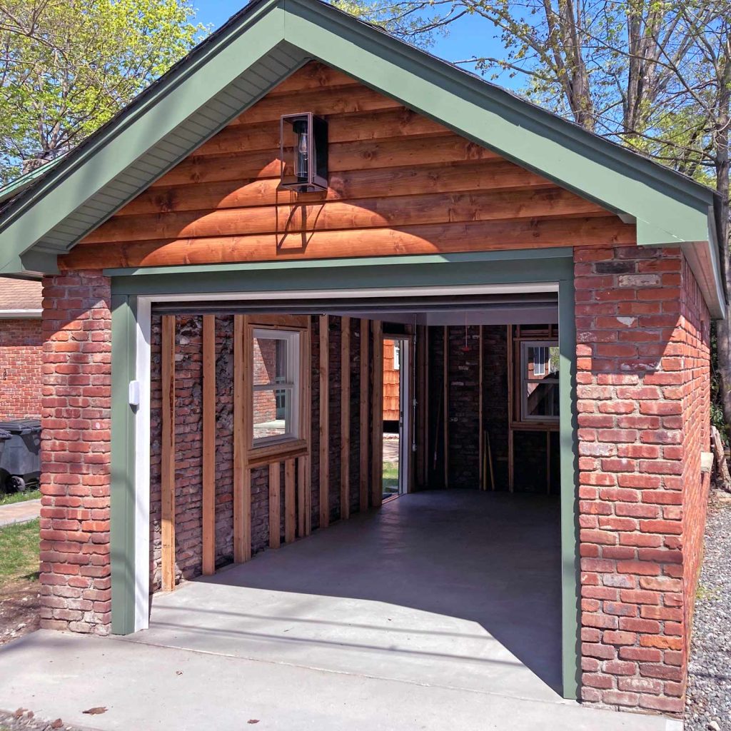 The exterior of a recently renovated brick detached garage by White Maple Construction