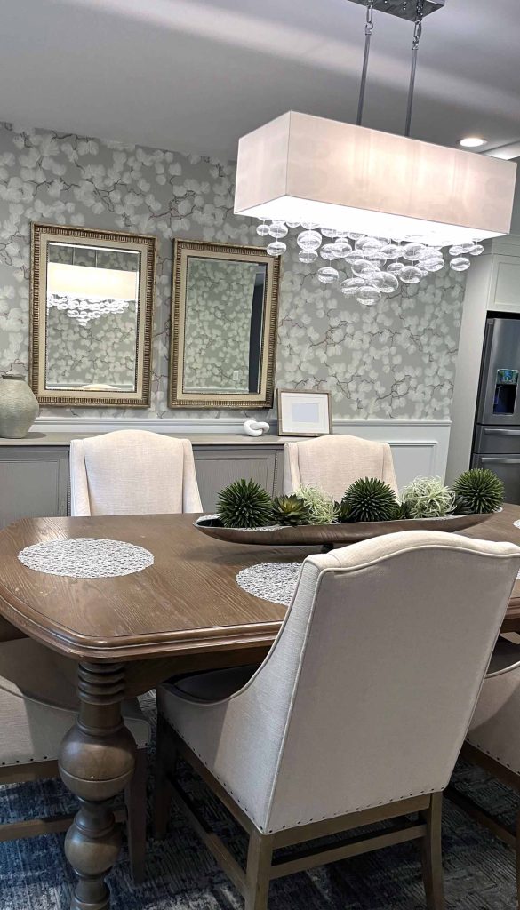 A dining room remodel with abstract floral wallpaper and a statement light by White Maple Construction