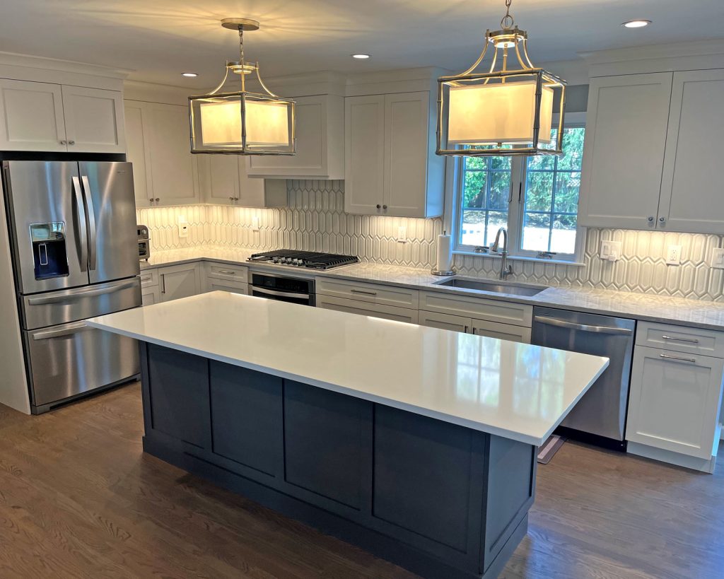 A modern kitchen remodel with white cabinets and wood floors by White Maple Construction