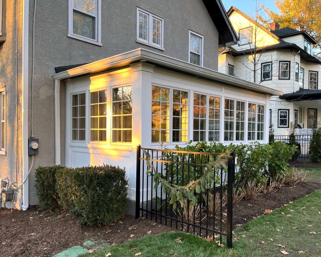 The exterior of a sunroom addition by White Maple Construction