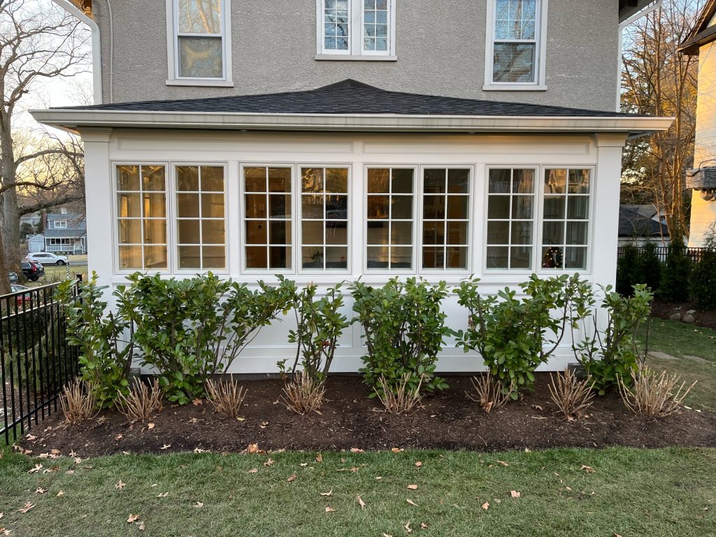 The exterior of a sunroom addition by White Maple Construction