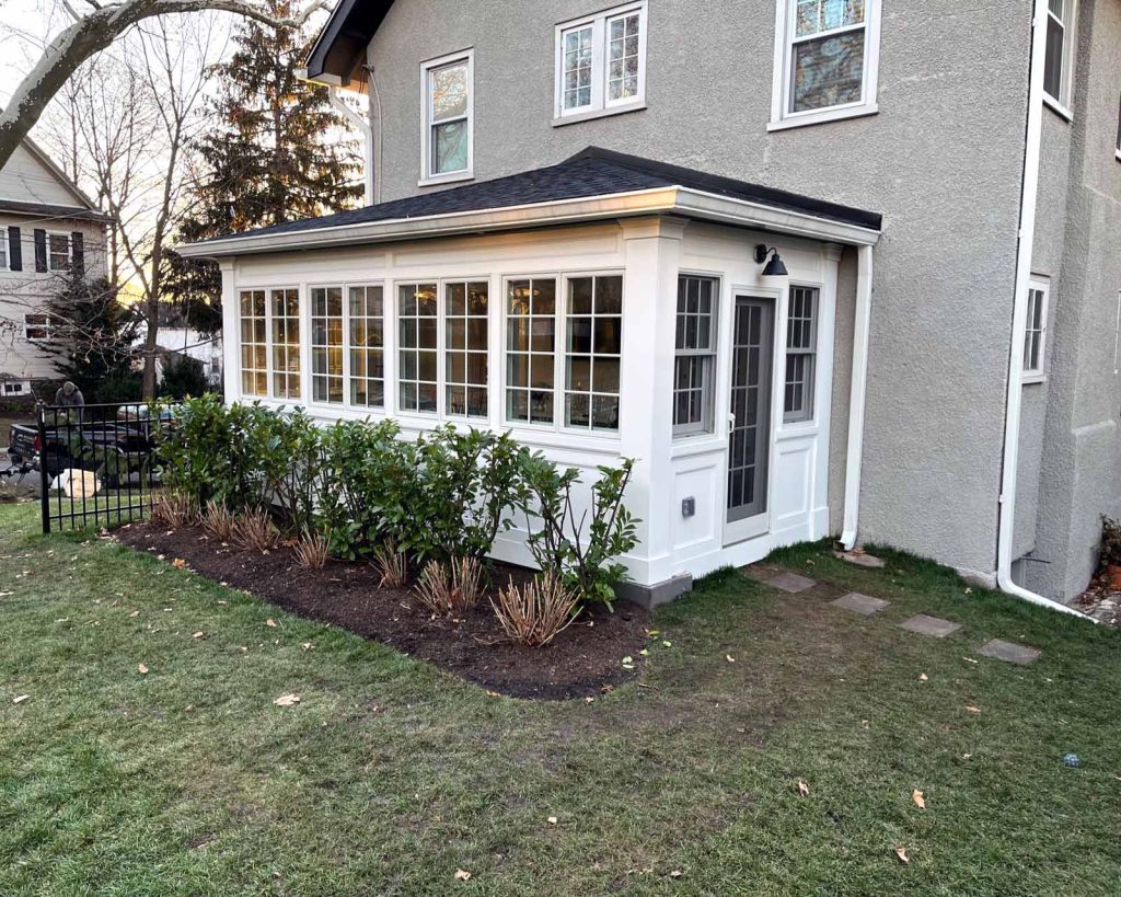 The exterior of a sunroom addition by White Maple Construction