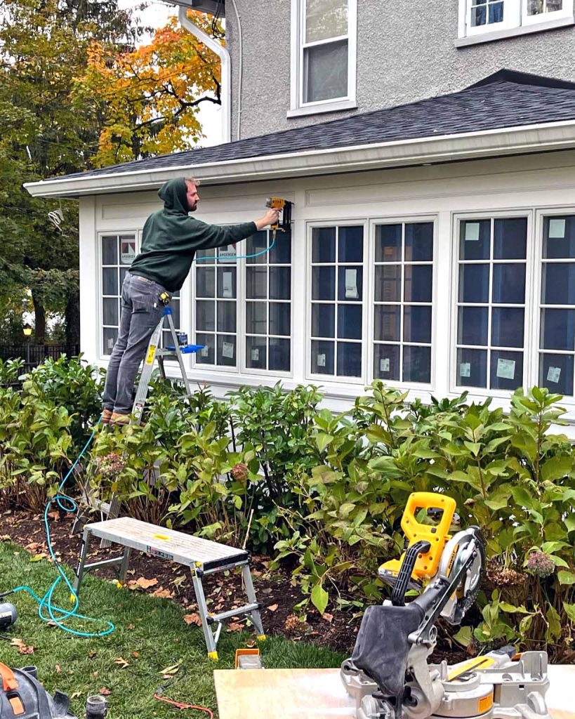 A contractor working on an the exterior of a sunroom addition in New Jersey